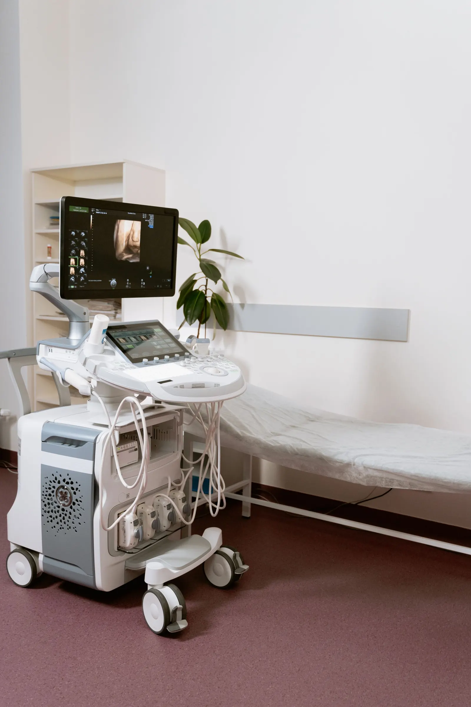 Ultrasound scanner beside an examination couch in a calm antenatal scan room